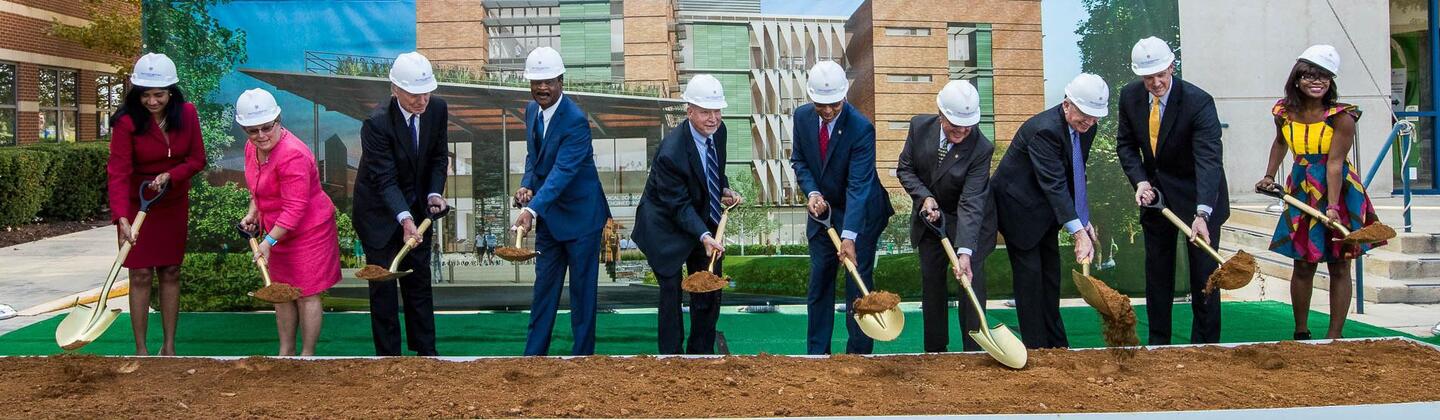 People breaking ground at the BSE with shovels