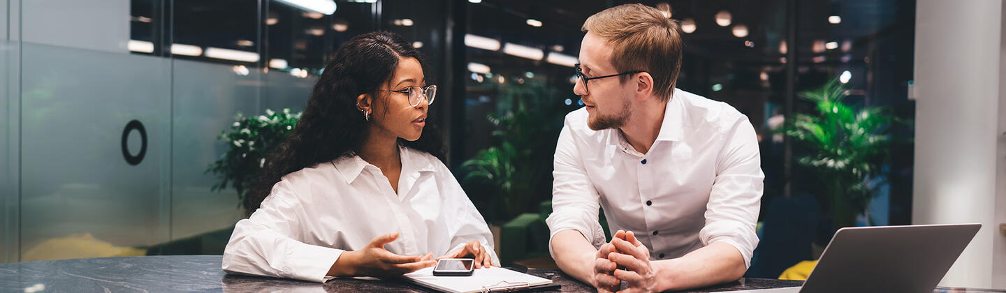 Male and female students talking.