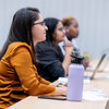 Students sitting in a classroom listening attentively