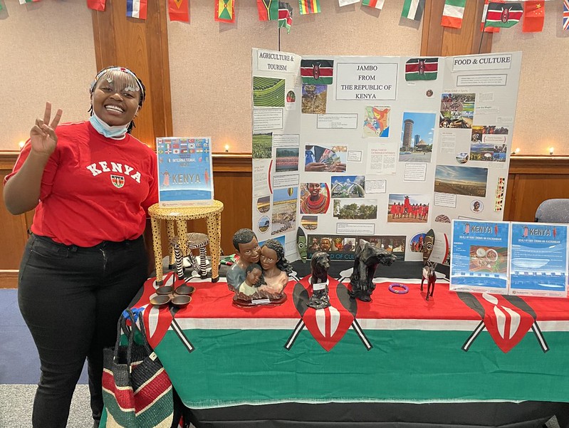 Table representing Kenya, staffed by Celine Mworia, a student at USG